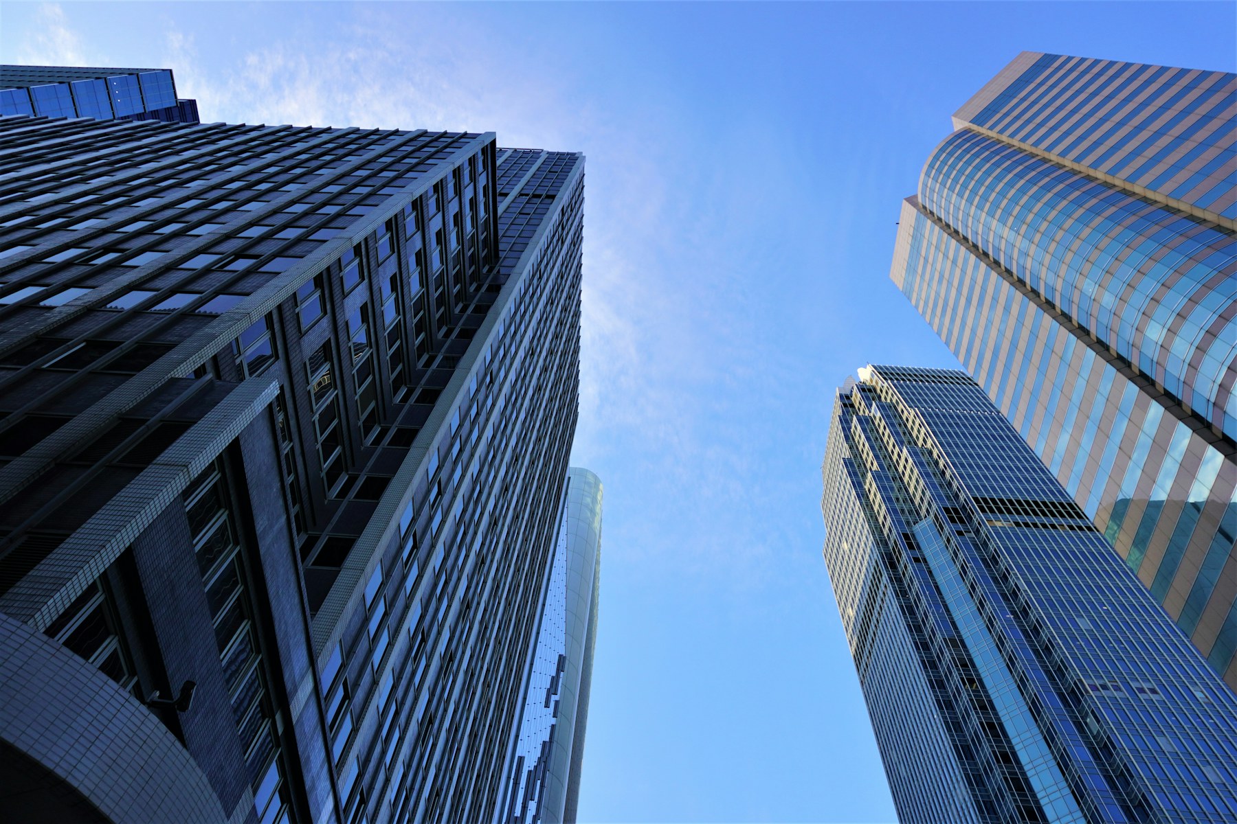 Blue glass office towers viewed from below